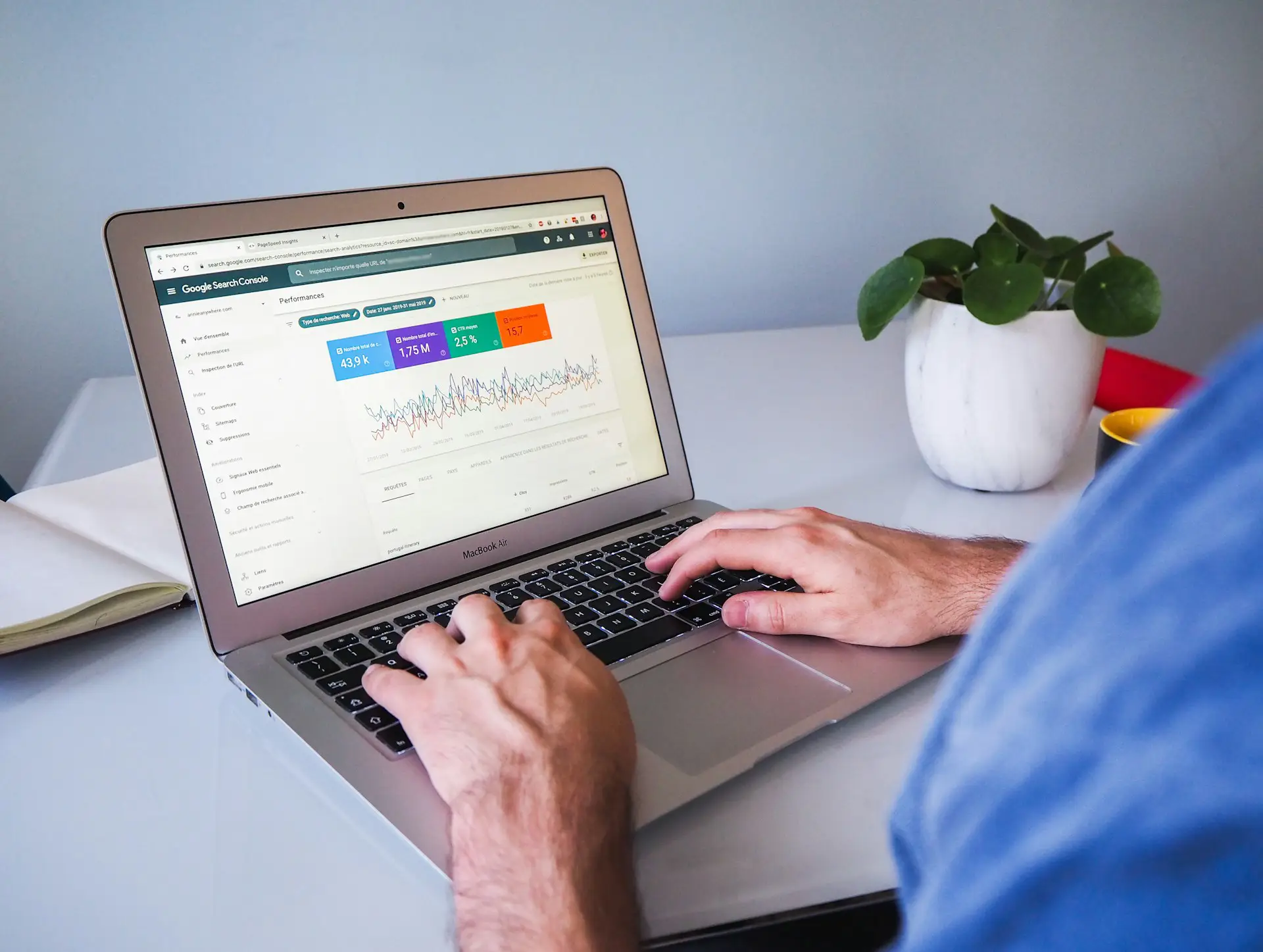 Website SEO consultant analyzing a site audit on a laptop, showing performance graphs and keyword data.